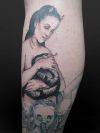 girl with snake tattoo on leg